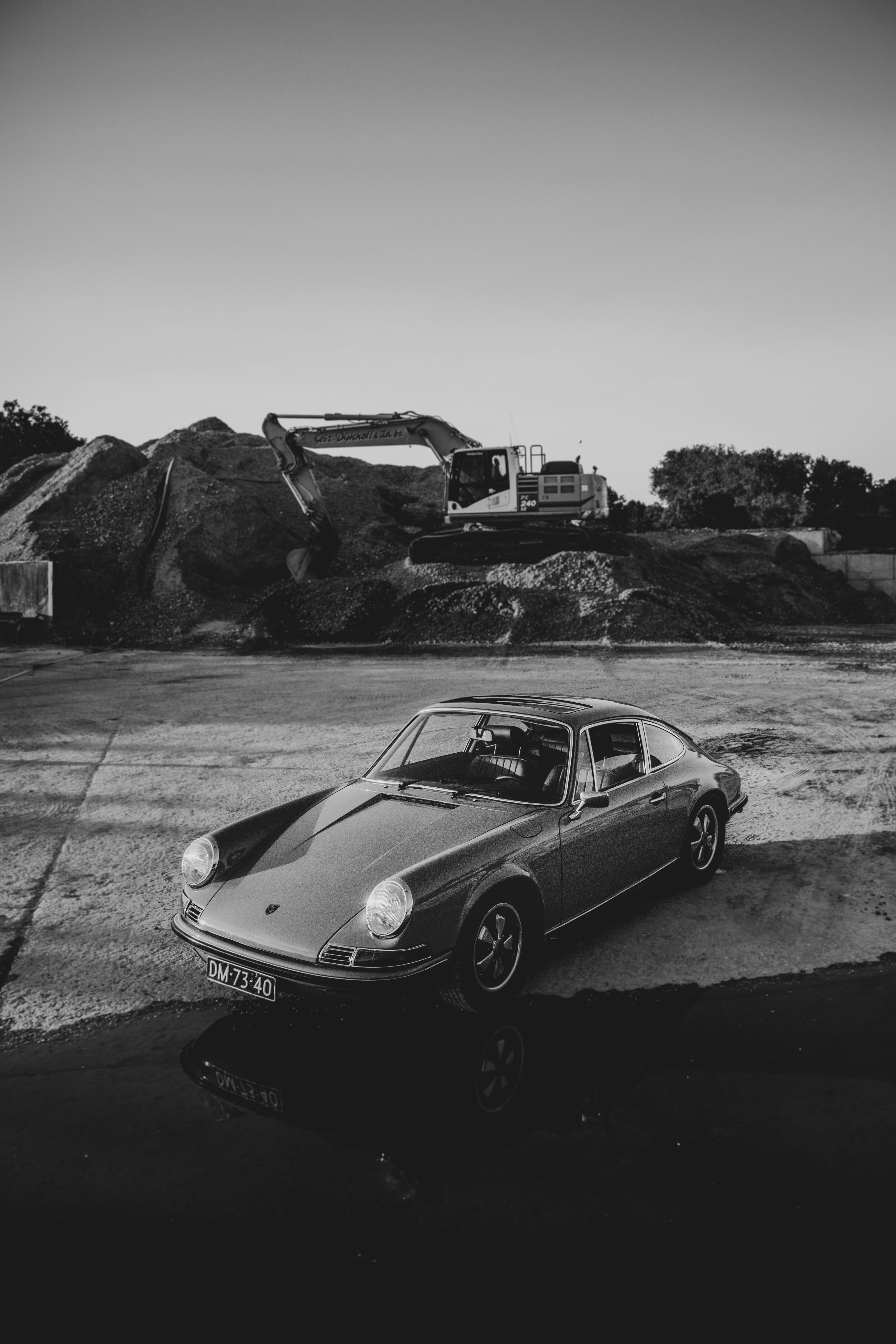 grayscale photo of coupe on road